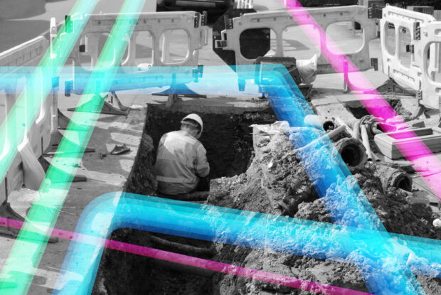 Man digging underground in black and white image with blue, green and pink lines.
